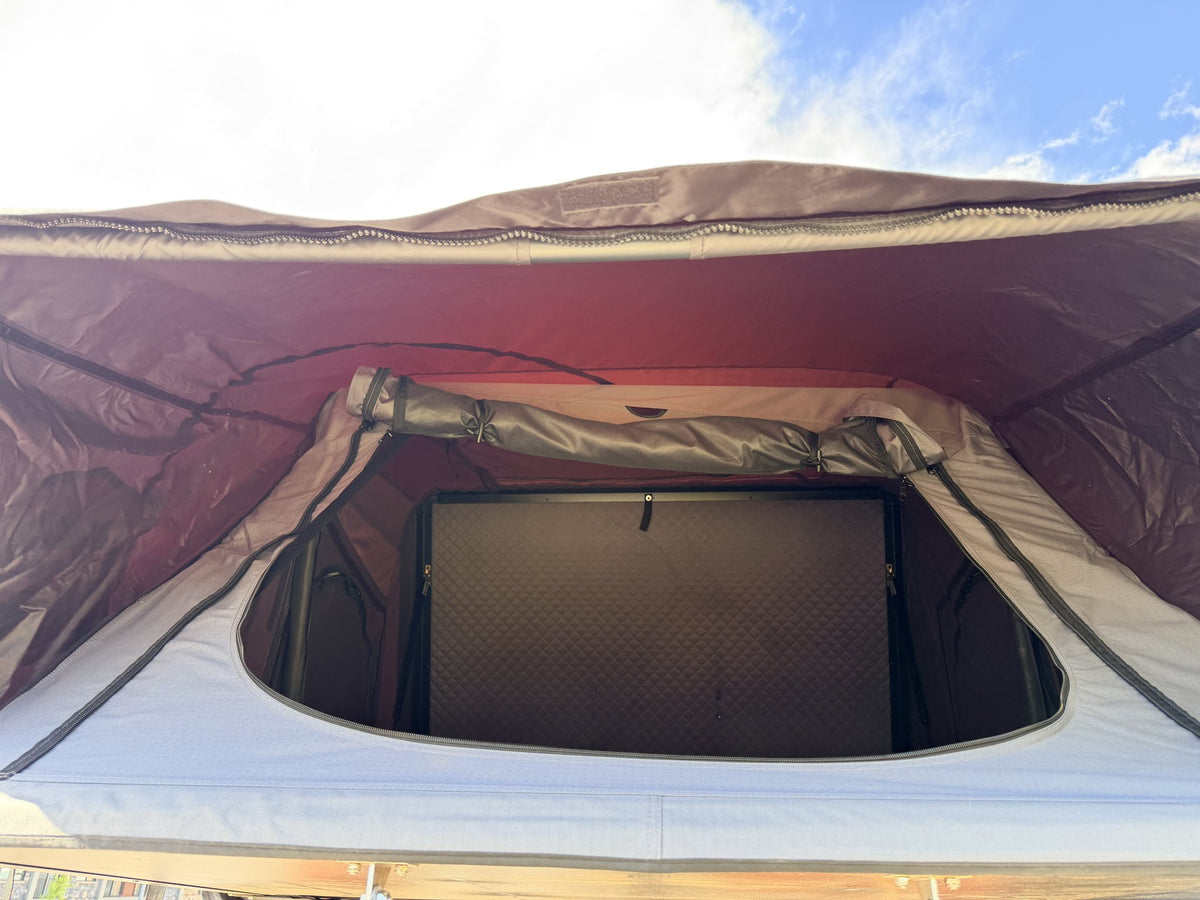 Looking up inside the tent at the skylight panel and spring bar rain cover — photo 6
