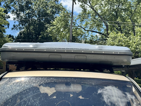 Front view of the closed James Baroud hardshell tent above the vehicle windshield, showing the full width of the XXL shell