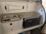 Escapod TOPO rear galley with two-burner stove, stainless counter and Dometic CFX fridge