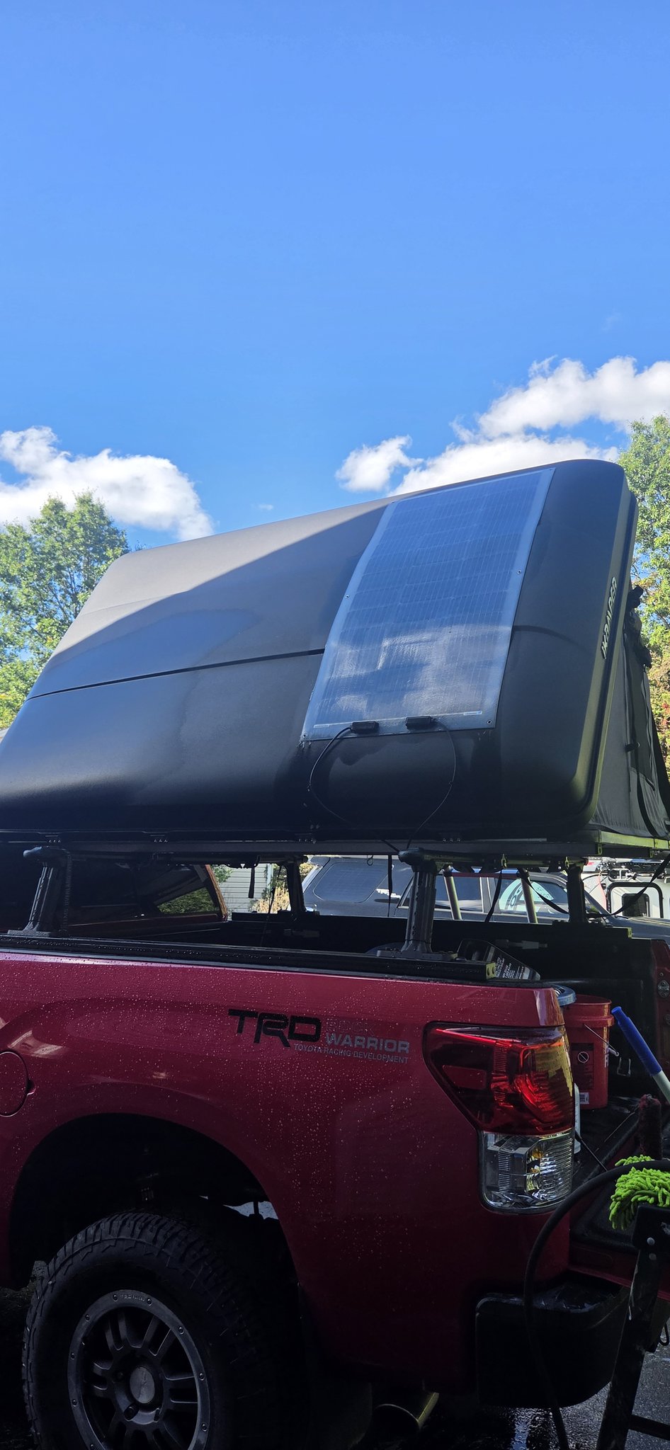 Closed Skycamp 3.0 hardshell with the Renogy 100W flexible solar panel mounted on the lid — photo 2