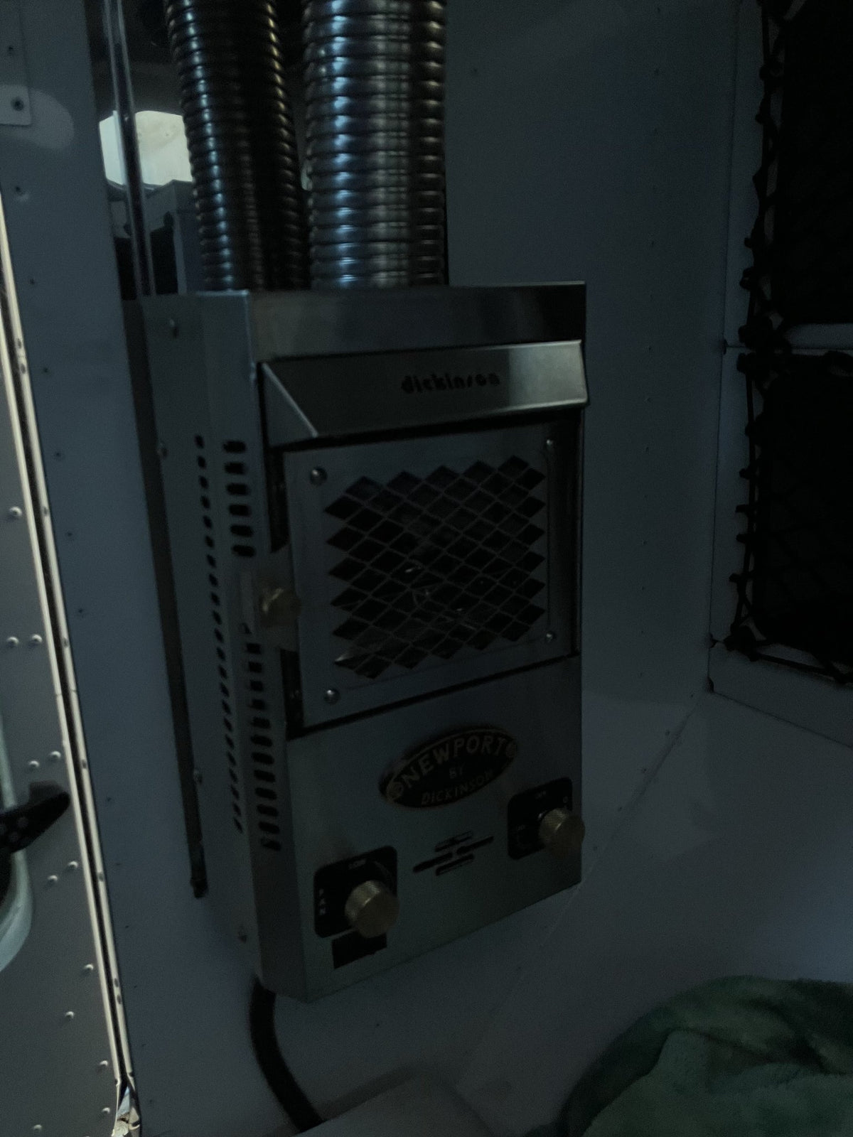 Dickinson Marine Newport propane cabin heater mounted inside the 2023 Mammoth Overland ELE, with its flexible exhaust duct and control knobs — photo 8