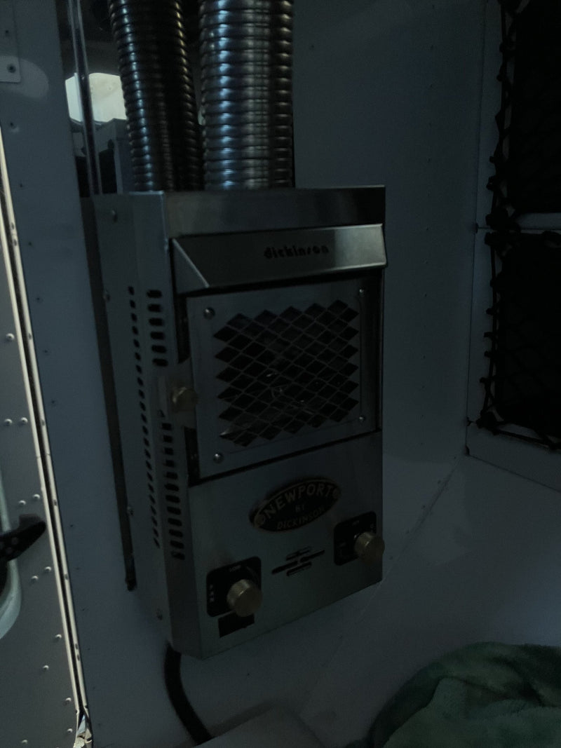 Dickinson Marine Newport propane cabin heater mounted inside the 2023 Mammoth Overland ELE, with its flexible exhaust duct and control knobs — photo 8