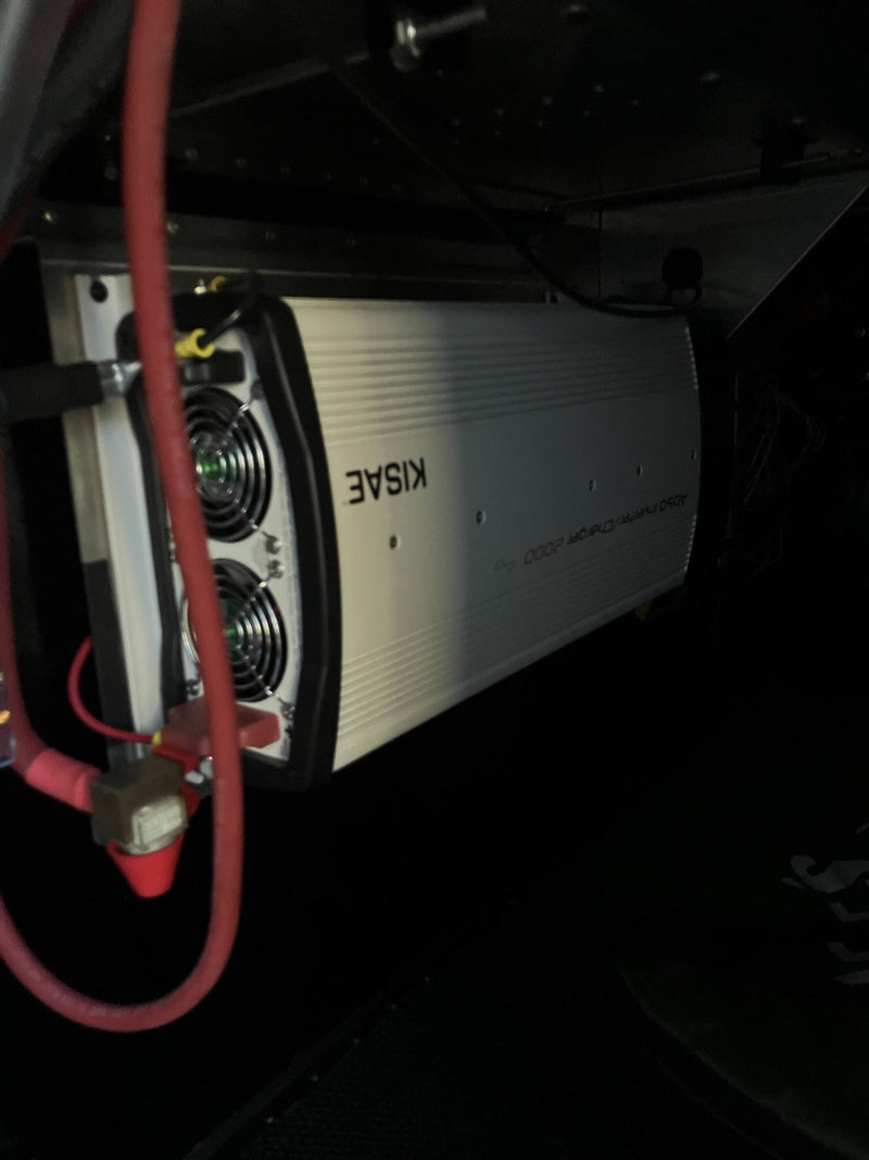 KISAE AD50 inverter/charger mounted in the electrical bay of the 2023 Mammoth Overland ELE, with heavy red battery cabling — photo 9