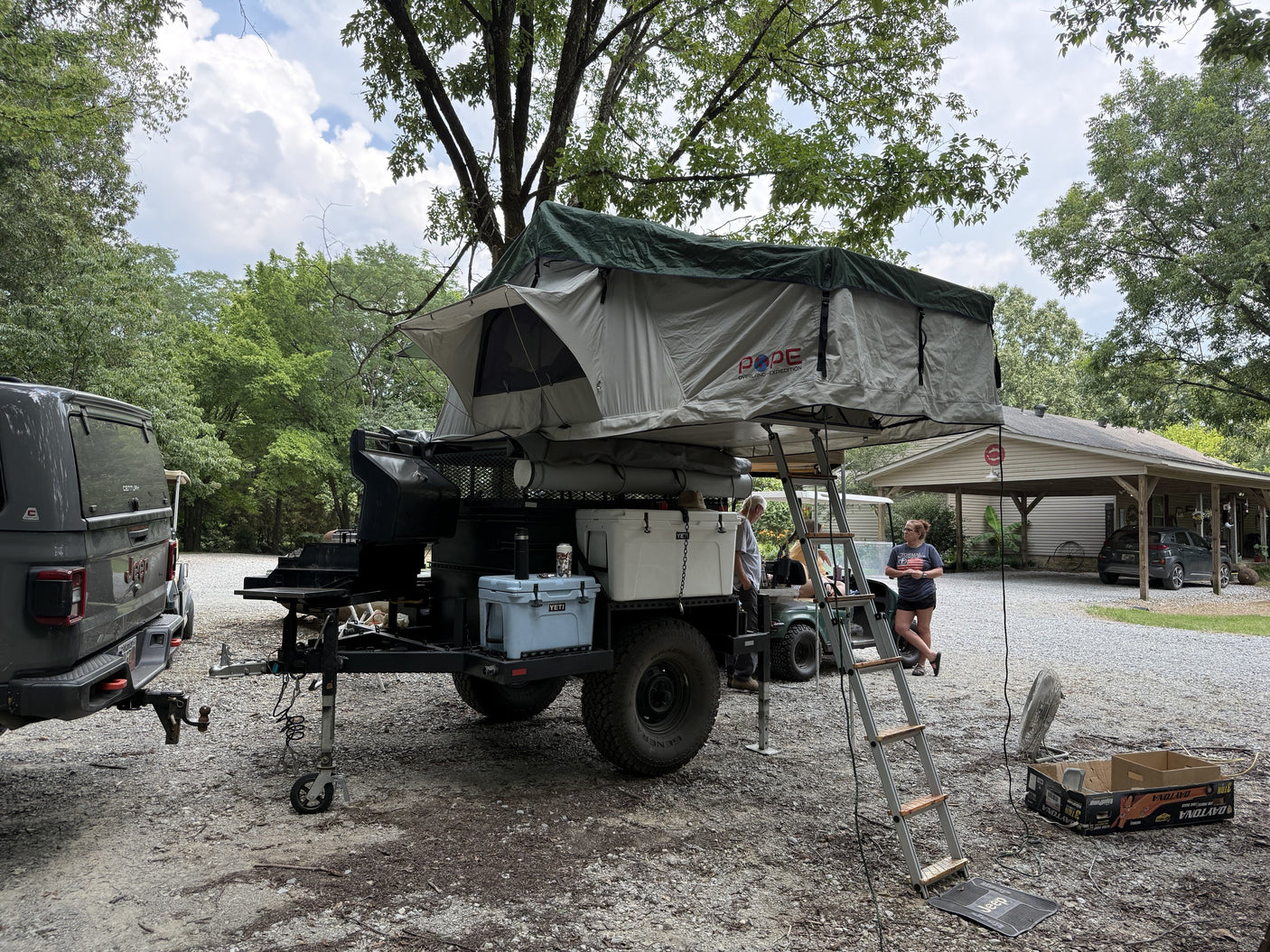The Pope rooftop tent and awning set up at a campsite