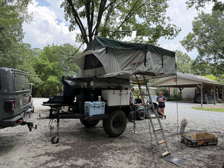The Pope rooftop tent and awning set up at a campsite