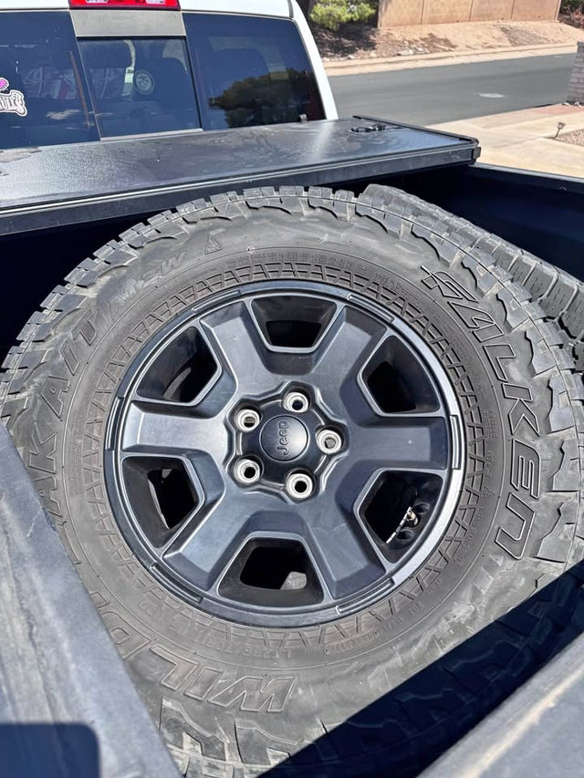 Four Jeep Rims with tires in Tucson, AZ (photo 1)