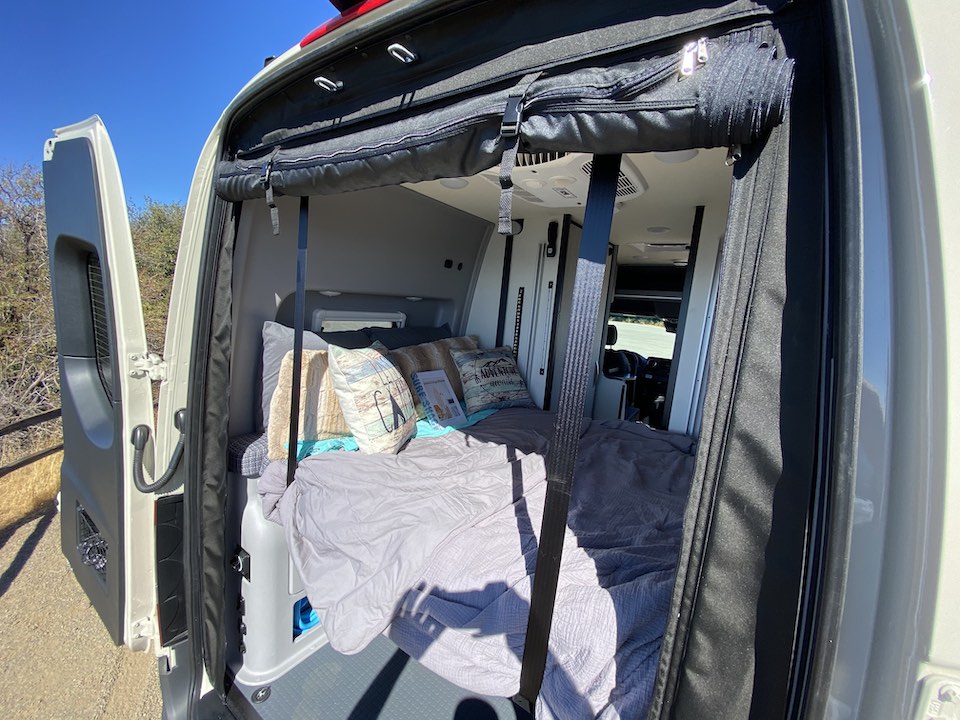  offers sweeping mountain views through a mesh screen.|Detailed RV rental floor plan shows space-saving design: lift bed — photo 2