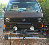 Front view of a brown VW Vanagon camper van with a front-mounted bike rack. Great rv rental for road trips & adventure!