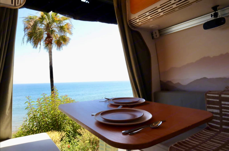  and kitchen.|Cozy RV rental bed with ocean & palm tree views. Features succulent pillows — photo 4