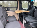 RV rental interior with convertible seating and dining table setup for travel.