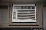 White built-in AC unit inside an RV rental, with a digital display set to 62 degrees for comfort.