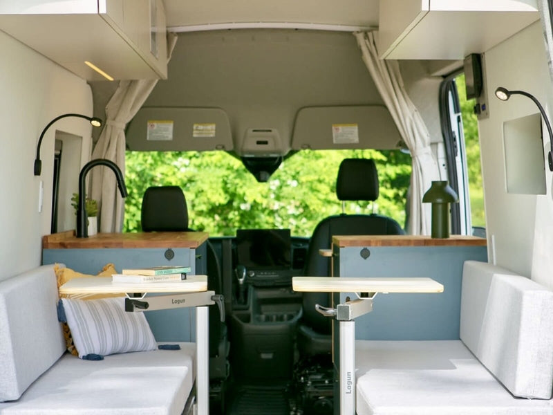  and an adjustable Lagun table by the side door of this camper van.|Discover a cozy rv rental interior! This camper van features a kitchenette — photo 6