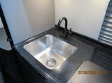  displaying HDMI2 at 1080p 60Hz.|RV rental interior featuring a modern kitchenette with microwave