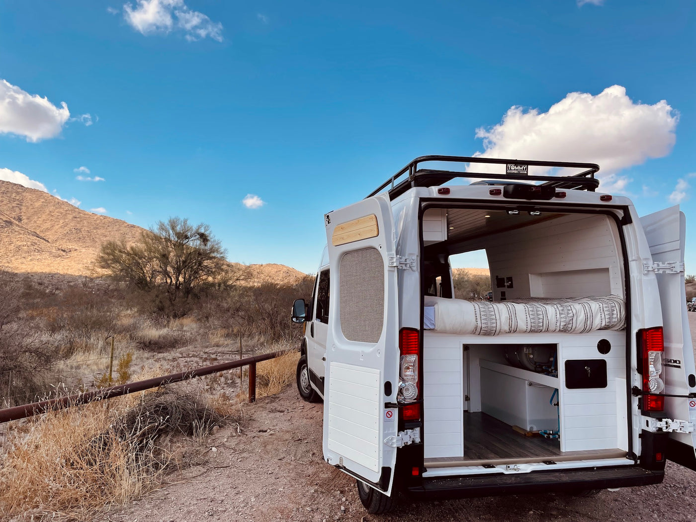  and mountain views.|Enjoy serene desert views from this cozy camper van bed. Perfect for your next RV rental adventure.|Inside this **RV rental**: a comfy bed — photo 5