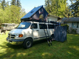 Experience van life! This white Dodge van features a rooftop tent, ladder, and privacy tent for convenient RV rental camping.