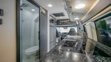 This modern RV rental camper van features a full kitchen with sink, induction cooktop, and a compact bathroom.