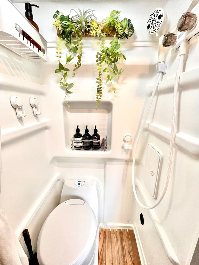  offering bright views from arched pop-top windows.|RV rental: open overhead storage cabinets reveal a functional camper interior with a window