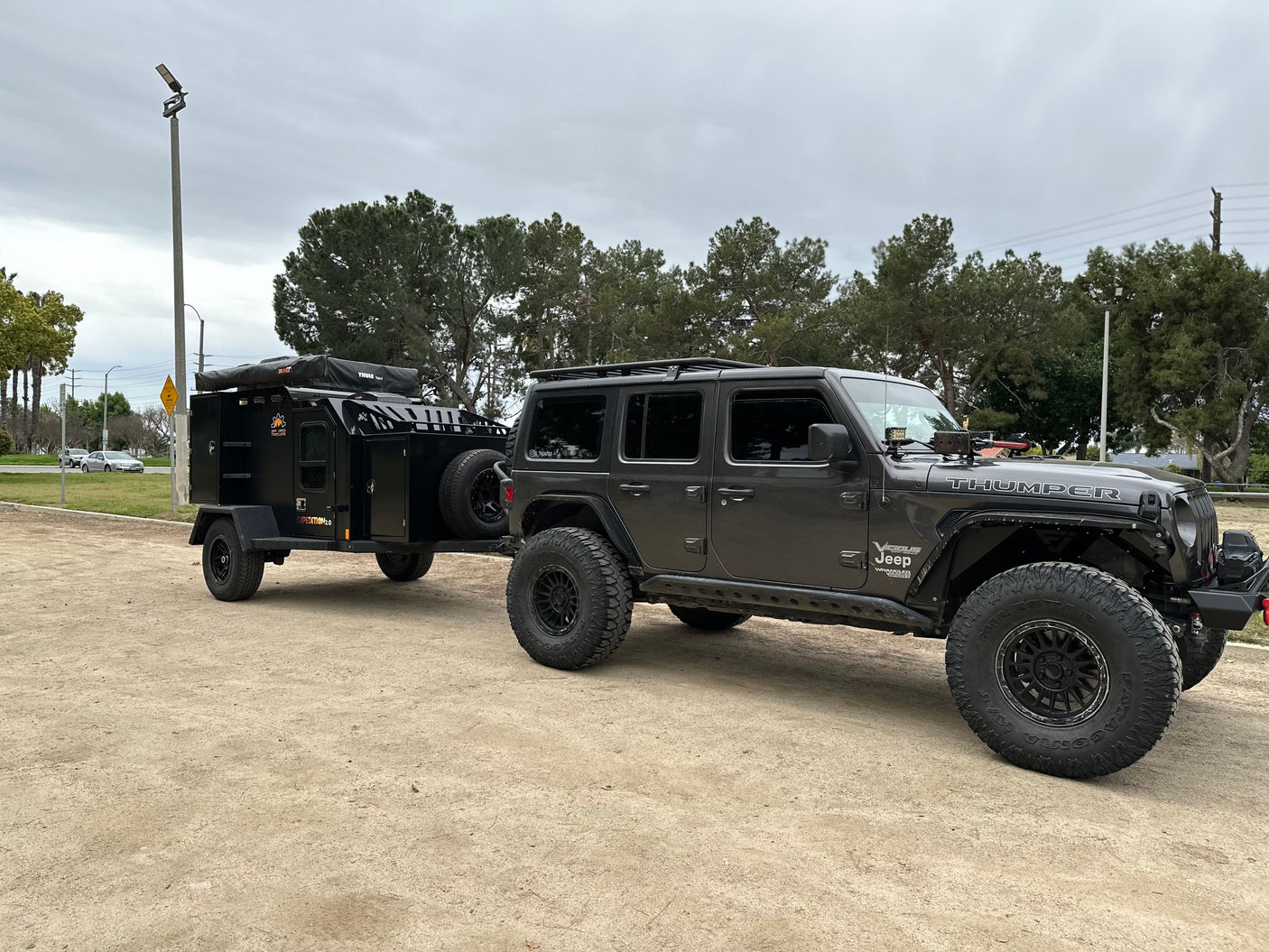 This custom dark grey Jeep Thumper and Expedition 2.0 off-road trailer combo is ideal for your next rv rental adventure.