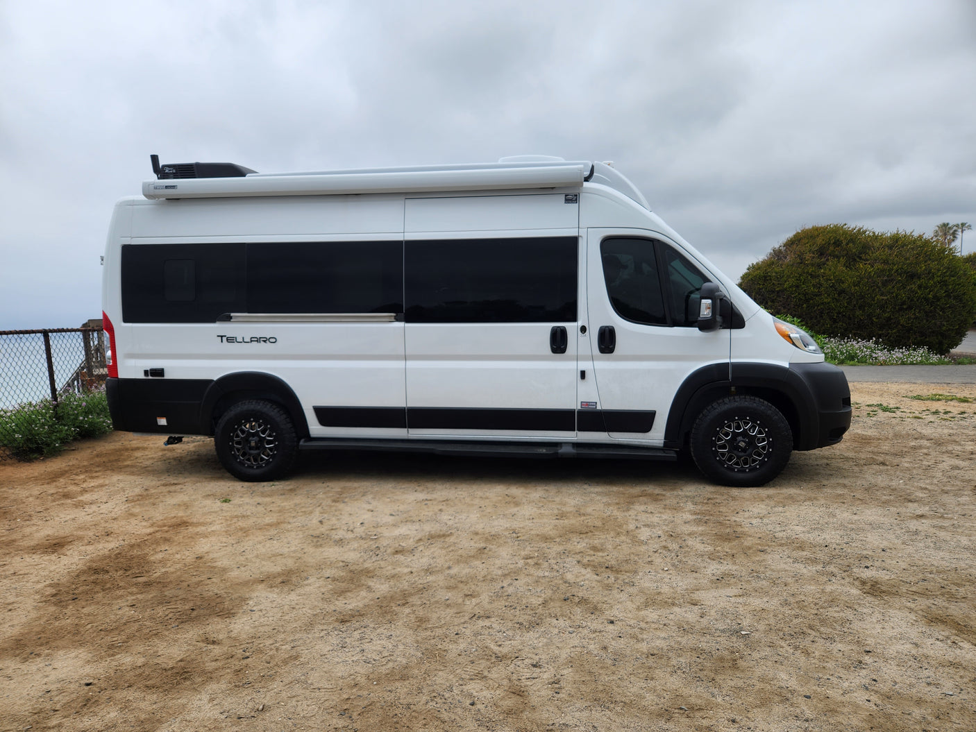 White Thor Tellaro RV rental. This modern camper van with black wheels is ready for your next road trip adventure.