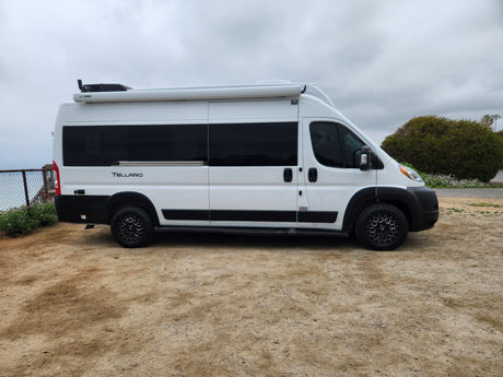 White Thor Tellaro RV rental. This modern camper van with black wheels is ready for your next road trip adventure.