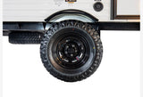 An RV rental's robust spare tire on a black steel wheel, with another tire tucked underneath for emergencies.