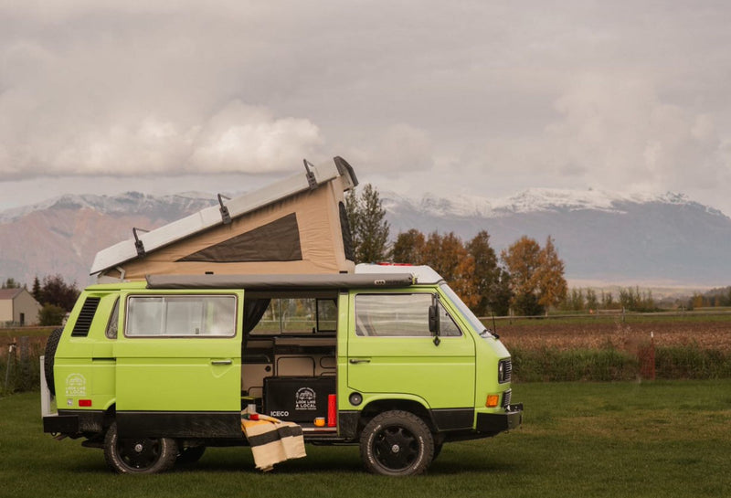 A bright green pop-top VW camper van — photo 1