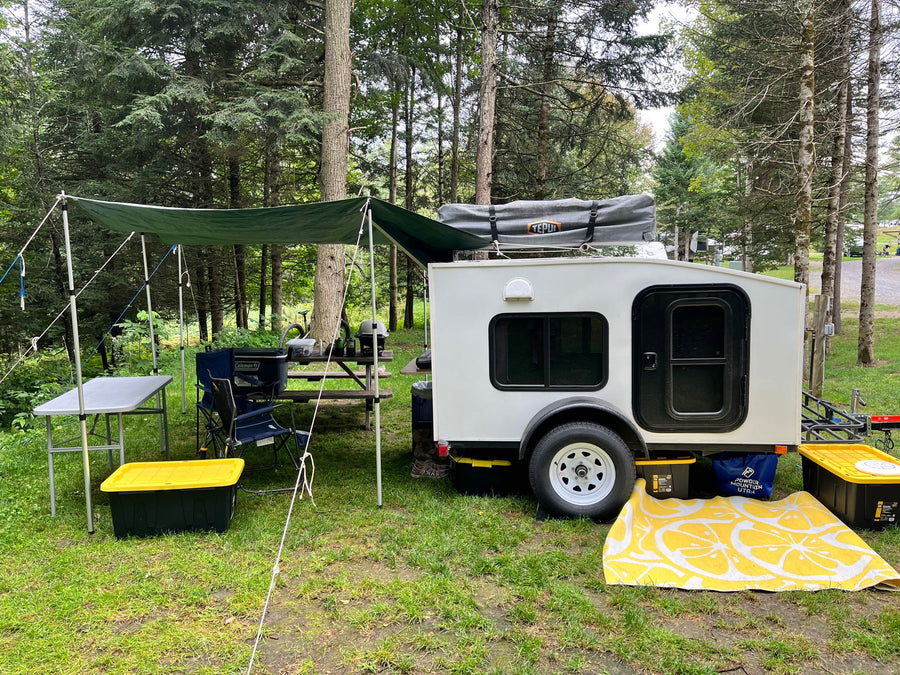  wooded campsite.|Cozy RV rental interior showing a small bed