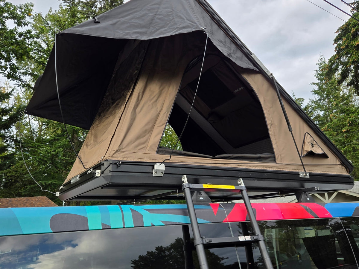  parked outdoors amidst trees.|RV rental camper van's custom rear kitchen: sink — photo 8