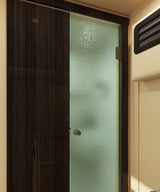 RV rental interior: Dark wood closet door next to a textured glass shower door with an AC vent on the right.