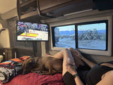 RV rental comfort: watching NBA with the dog & wine. Unique desert landscape outside, mountains afar. Cozy travel!
