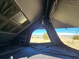 Experience camping comfort! This RV rental features a rooftop tent with a comfy mattress and beautiful lakeside views.