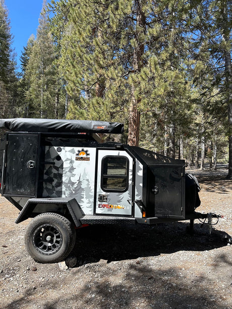 Explore the wilderness with this robust Off Grid Trailers Expedition 2.0 off-road camper, perfect for an rv rental adventure.