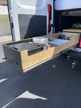 This rv rental features an extended rear pull-out kitchen drawer, organized with a portable stove, water filter, and cooking essentials for camper van trips.