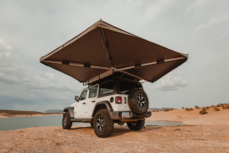 White Jeep Wrangler, equipped with a large awning, parked by a desert lake. Ideal for an RV rental outdoor escape. — photo 10