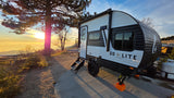 Golden hour camping with our rv rental, a Go Lite Skybreaker travel trailer, parked at a scenic site overlooking a stunning sunset.
