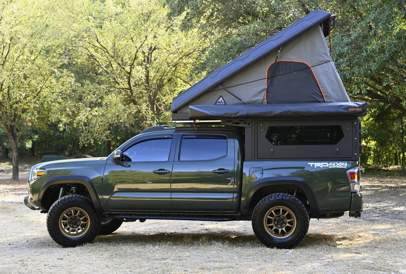 Green Toyota Tacoma TRD 4x4 truck camper with Alu-Cab rooftop tent, ideal for your next RV rental adventure. — photo 9