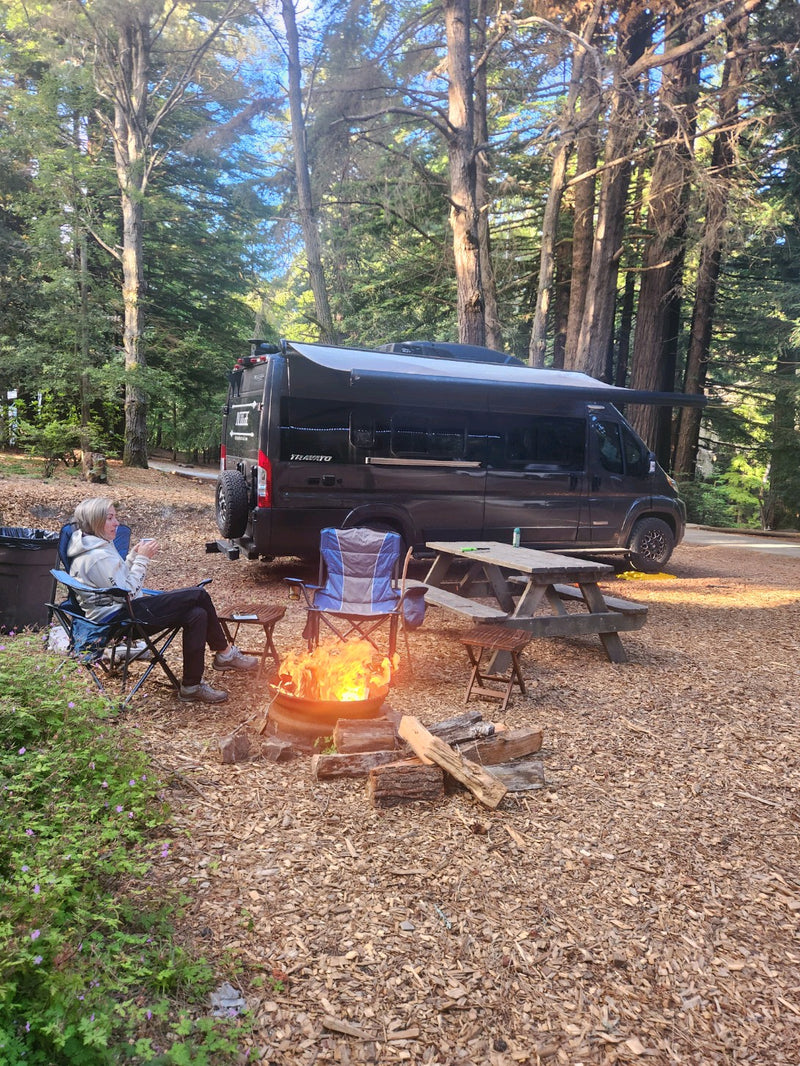  and control panel.|Stainless steel two-burner gas stove with black grates inside an RV rental. A compact kitchen essential for your travels.|RV rental kitchen featuring a stainless steel sink — photo 11