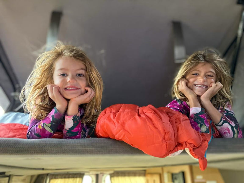 Happy girls in an RV rental bunk, ready for cozy family travel adventures. — photo 2