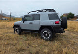Rugged grey Toyota FJ Cruiser off-road SUV, ready for adventure in a dry field. An ideal option for a nature-focused rv rental trip.