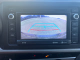 A modern car stereo and display in an RV rental, showing the rear camera view with blue and red guidelines.