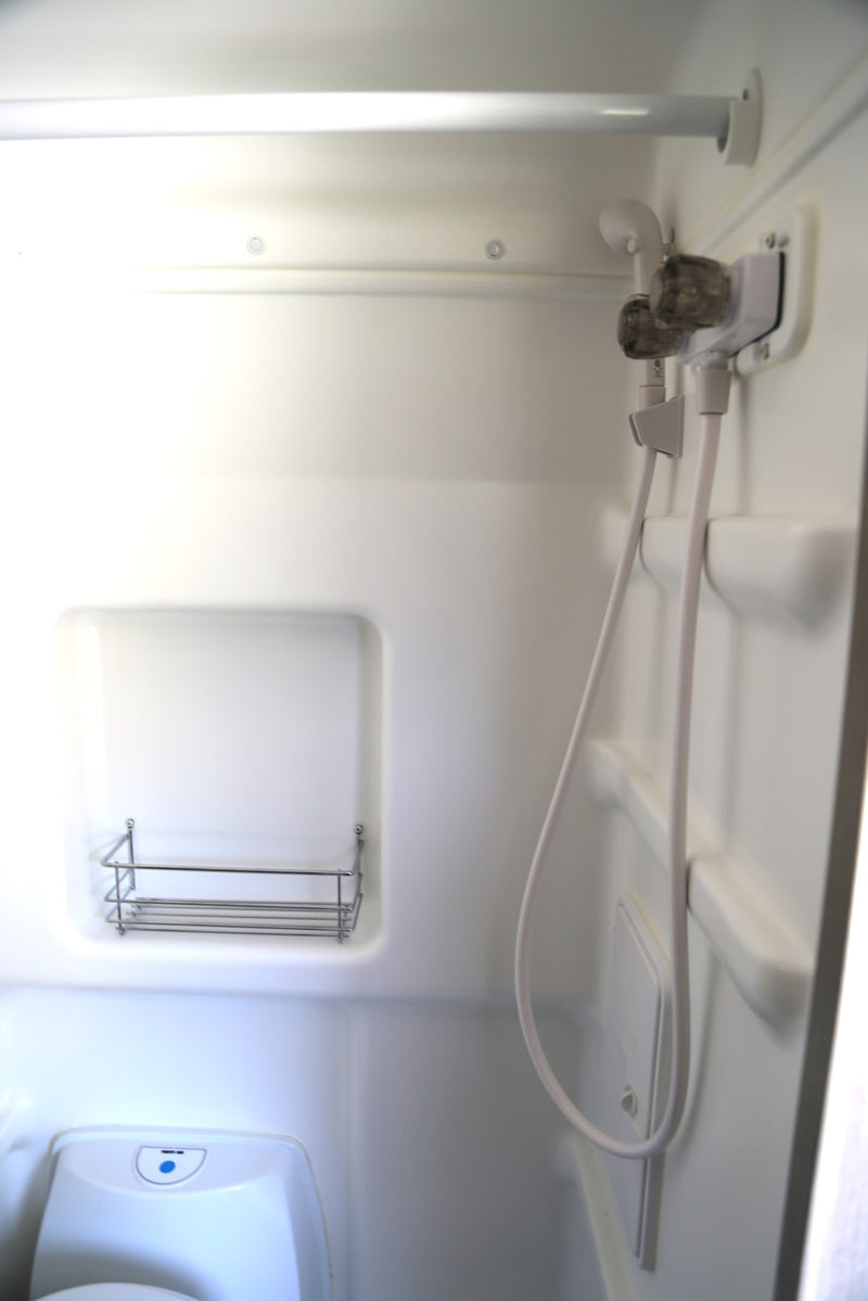  featuring a mesh screen for peaceful travel.|This RV rental's rear offers a comfy bed — photo 5