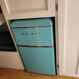 This compact, retro blue Galanz refrigerator is a stylish addition to our RV rental.