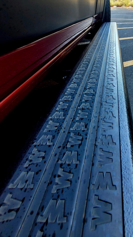 Close-up of an RV rental's side step with embossed 'W' pattern for secure footing, enhancing accessibility.