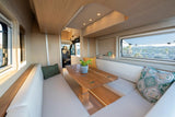 Experience comfortable mobile living with this modern RV rental's spacious dining area, perfect for scenic desert views.