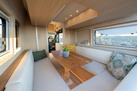 Experience comfortable mobile living with this modern RV rental's spacious dining area, perfect for scenic desert views.