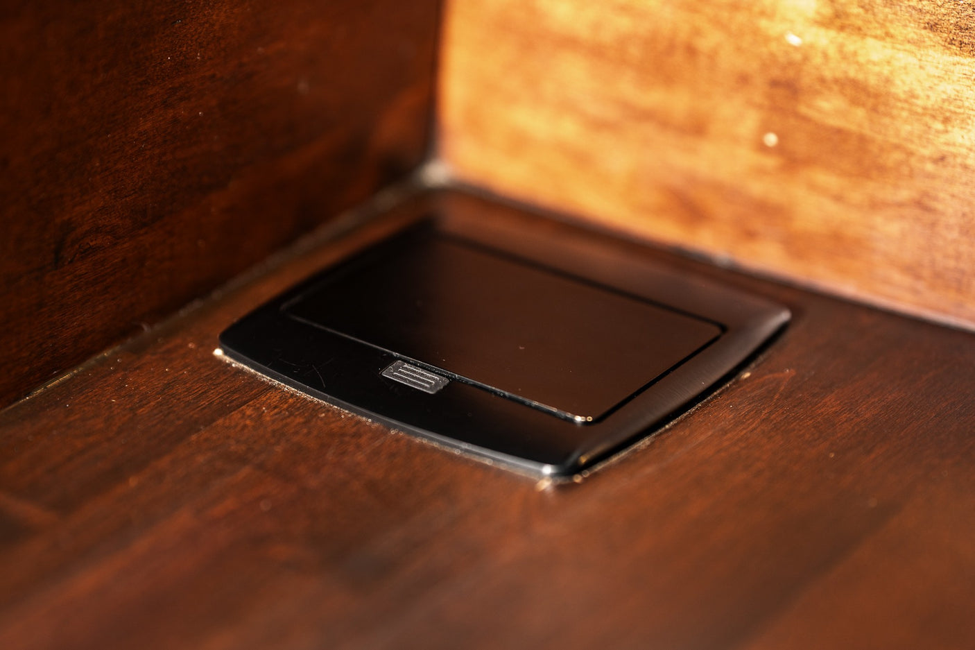 RV rental wood interior features a sleek, built-in black power outlet for easy device charging.