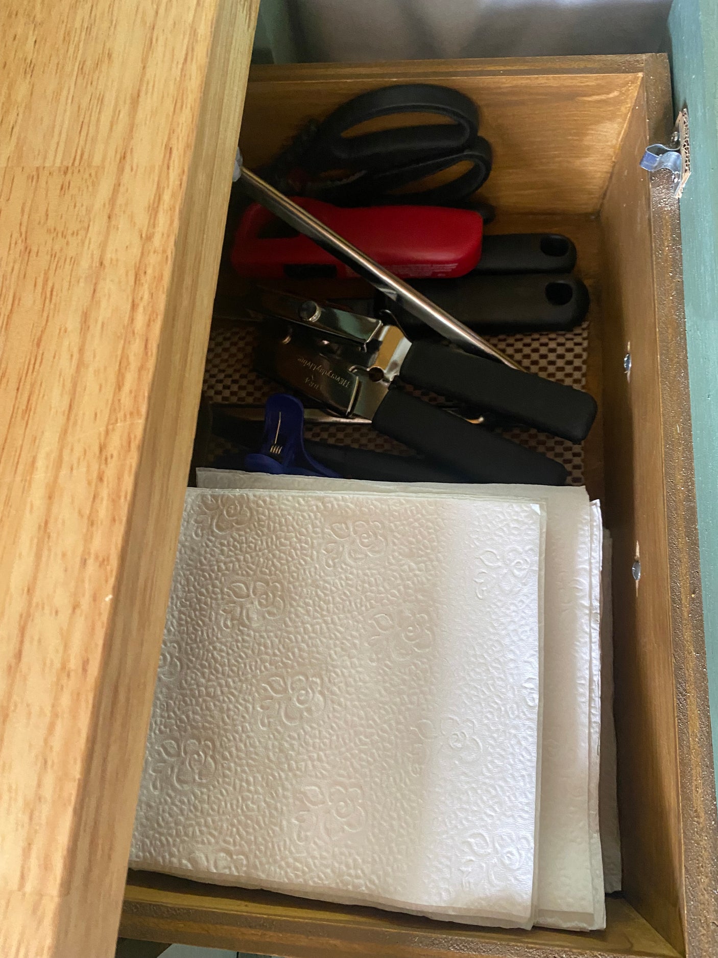 RV rental kitchen drawer: Scissors, can opener, and patterned paper towels. Compact essentials for travel.