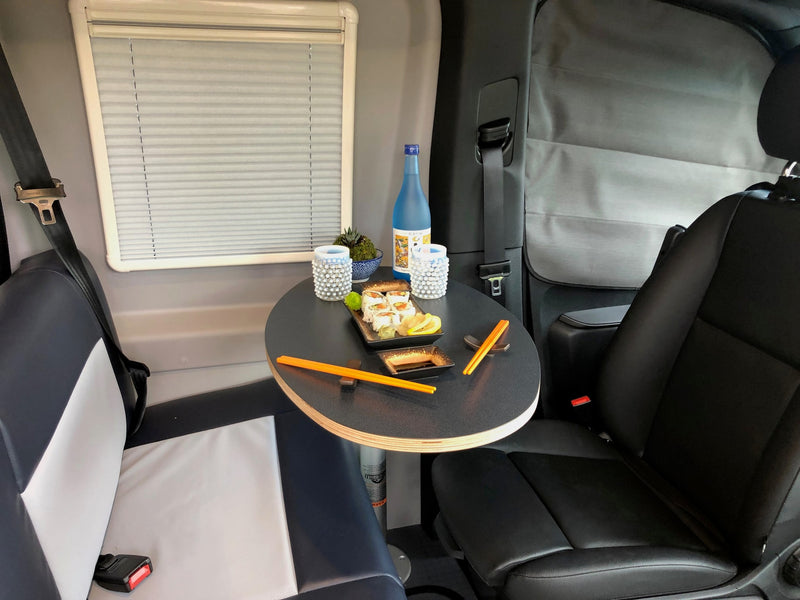 Cozy RV rental dining space: enjoy sushi on a small table, with comfy seating and window shades for a relaxing travel meal. — photo 6