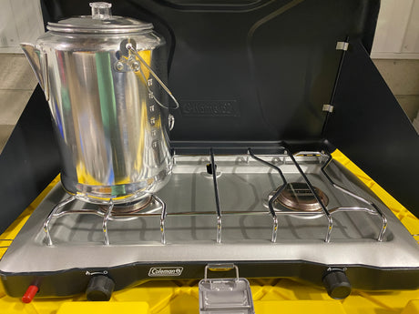 Coleman camping stove with a coffee percolator, ideal for RV rental adventures and outdoor cooking.