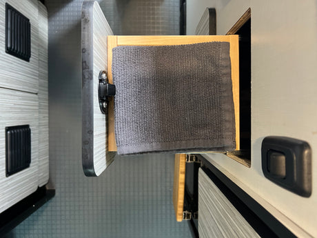 RV rental interior: Open drawer with a grey towel, showing practical storage inside this camper van.